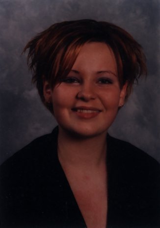 Jeune femme blonde de face avec un pull échancré.