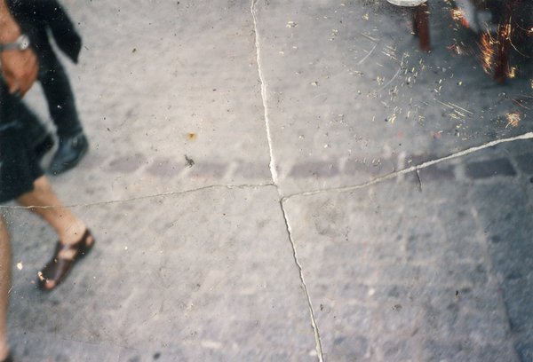 Rue avec jambes de passants. Image déchirée reconstituée.