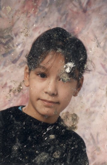 Visage de petite fille brune à frange.