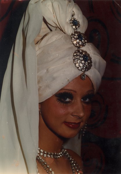 Visage de danseuse de revue avec turban sur la tête et collier en strass.